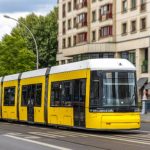 yellow-tram-gliding-past-curved-facade-urban-public-transport